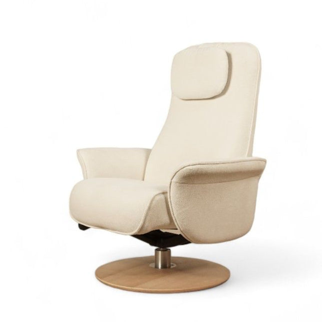 A beige upholstered nursing recliner chair with an ergonomic design, featuring an adjustable headrest and armrests, seated on a circular oak wood base.
